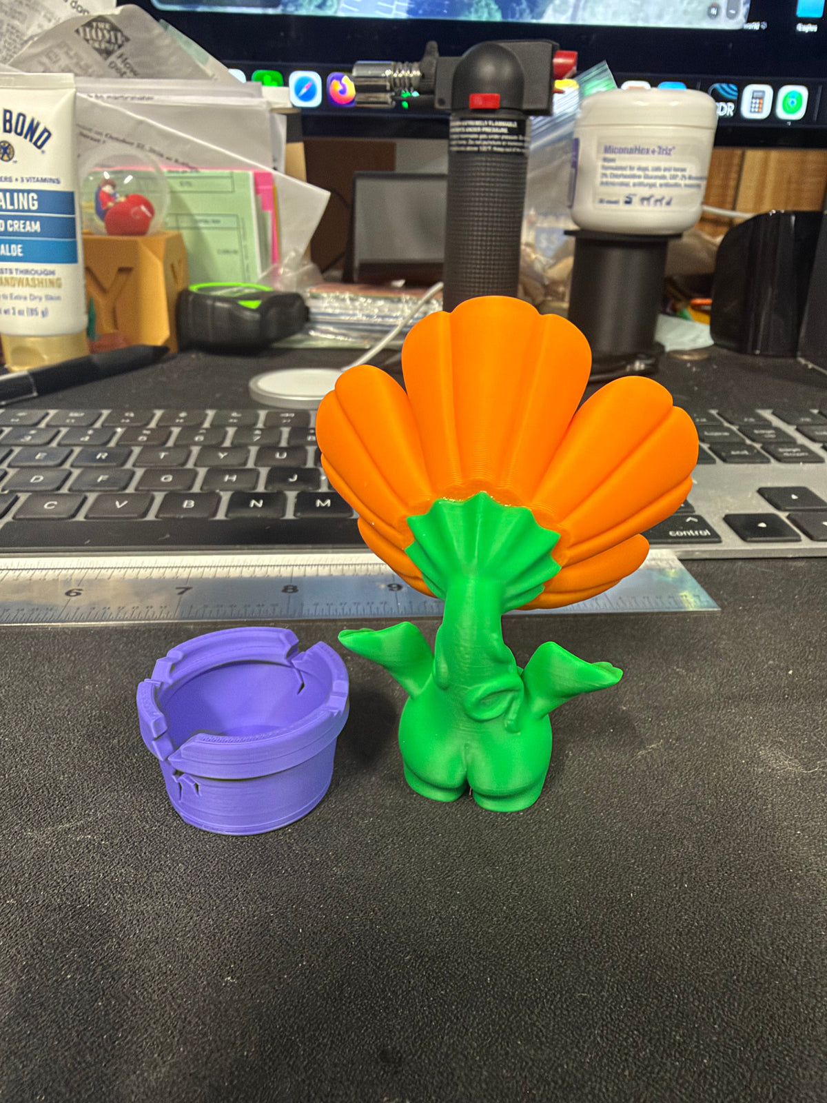 Flower figurine removed from its included purple pot