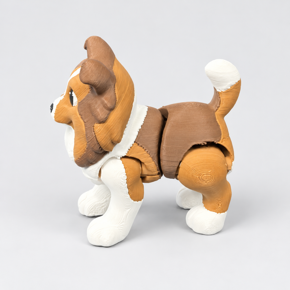 Side view of Sheltie fidget showing articulated body and white-tipped tail.